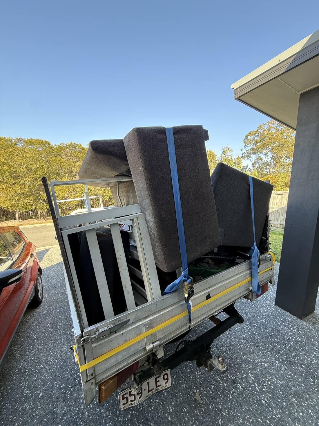 Trailer packed with couch cushions and old furniture